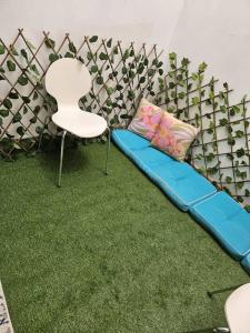 a couch and two chairs in a room with grass at Sunset Senegal in Rufisque