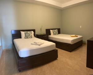 En eller flere senge i et værelse på Spencer Residencial APARTAMENTOS