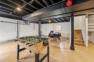 a ping pong table in a room with a dining room at New 10-min to Downtown in Oak Park