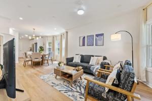 a living room with a couch and a table at New 10-min to Downtown in Oak Park