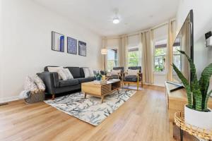 a living room with a couch and a table at New 10-min to Downtown in Oak Park