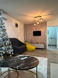 a living room with a christmas tree and a couch at NiLa in Ivanjica