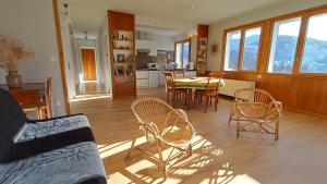 a living room with a table and chairs at Gite La Cueille in Saint-Claude