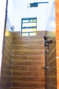 a bathroom with a staircase with a bench on it at Tropical lodge in Kakamega