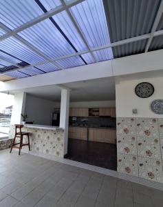 a room with a kitchen with a table and a ceiling at Ayoolasudi in Kerobokan