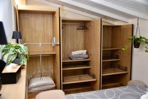 a room with a closet with wooden shelves at Como's Hill Apartments in Lipomo +9 photos