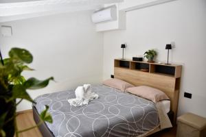 a bedroom with a bed with a stuffed animal on it at Como's Hill Apartments in Lipomo