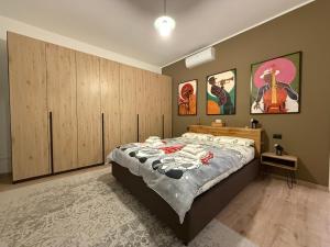 a bedroom with a large bed and wooden cabinets at Como's Hill Apartments in Lipomo