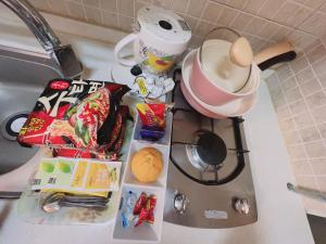 a kitchen counter top with food and a pot on top at Whouse-sinchon in Seoul +33 photos