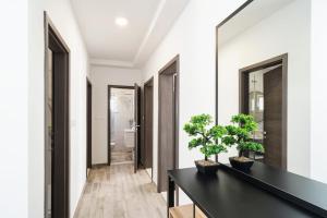 a hallway with a black table and a mirror at 3-bedroom Sea View Home with Private Parking in Mokošica +21 photos