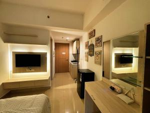 a bedroom with a bed and a television in a room at Narra Modern Living in Jakarta