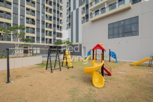a playground in front of a building with play equipment at Narra Modern Living in Jakarta