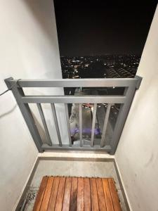 a balcony with a view of a city at night at Narra Modern Living in Jakarta +1 photo