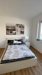 a white bedroom with a large bed in it at Villa LaLeo in Künzelsau