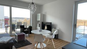 a living room with a white table and chairs at Villa LaLeo in Künzelsau