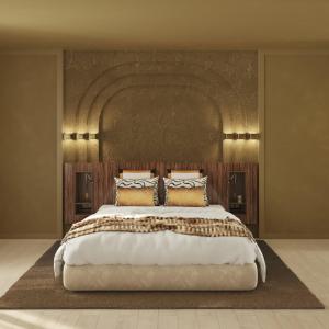 a bedroom with a large bed with a large headboard at Hotel Atlantiis Suites Near Kashi Vishwanath temple in Varanasi