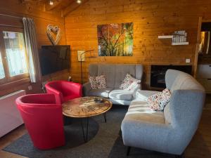 a living room with a couch and two chairs and a table at Romantikhütten 1 & 24 in Stamsried