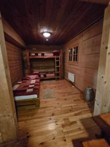 a room with two bunk beds in a log cabin at Koliba Studencka Politechniki Warszawskiej in Caryńskie