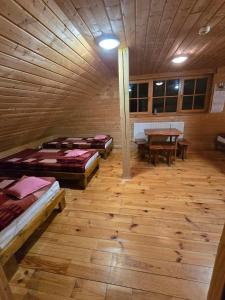 a room with four beds and a table in it at Koliba Studencka Politechniki Warszawskiej in Caryńskie