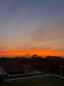 a sunset from the balcony of a house at Ayoolasudi in Kerobokan
