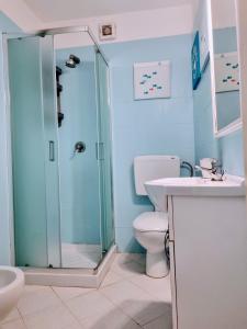 een badkamer met een douche, een toilet en een wastafel bij Casa ARLECCHINA in Rio Marina