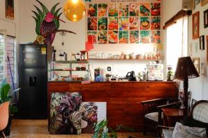 a kitchen with a counter and a refrigerator at La Palmera Hostel in Cali