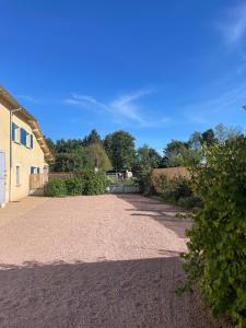 a gravel driveway in front of a house at Maison de Jules in Le Coteau
