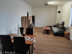 a living room with a table and a couch at APARTMÁN KATKA Stošice - Liptovský Mikuláš, súkromue & pohodlie in Liptovský Mikuláš +5 photos