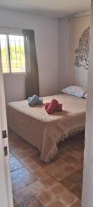 a bedroom with a bed with two pillows on it at Hostal El Portillo in Arroyo de Los Patos