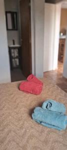 two towels sitting on top of a bed at Hostal El Portillo in Arroyo de Los Patos