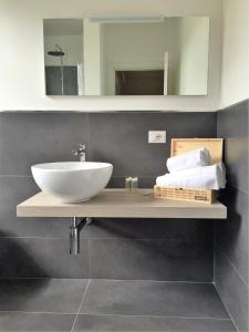 a bathroom with a sink and a mirror at Locanda Rabaya' in Barbaresco +19 photos