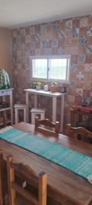 a dining room with a table and a window at Hostal El Portillo in Arroyo de Los Patos +14 photos