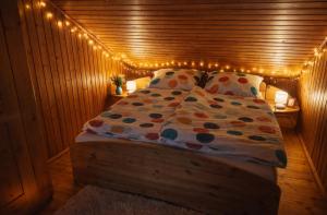 a bedroom with a bed with lights on it at Haus Sommerseit'n Ruhe-Natur-Genuss in Hirschbach