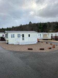 a row of mobile homes parked on the side of the road at Annas Escape Burnside Moray in Fochabers