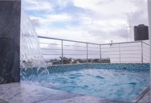 a large swimming pool with a water fountain at Byk in Nagua