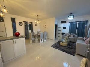 a kitchen and living room with a couch and a table at Byk in Nagua