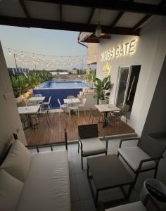 a patio with tables and chairs and a swimming pool at Airport Transit KINGS HOTEL in Katunayake