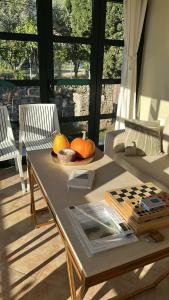 a living room with a table with pumpkins on it at Orange Garden in Himare