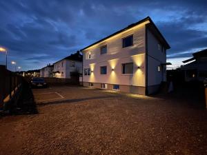 a building with lights on the side of it at Oddernesveien 7 in Kristiansand