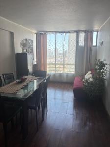 a living room with a dining room table and a couch at Campanario 104 in Iquique