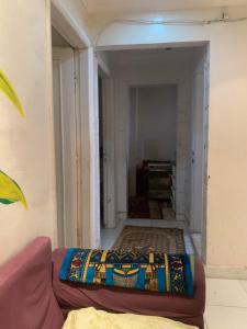 a living room with a couch and a hallway at Simple gem in port said in Port Said