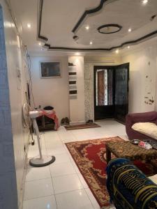a living room with a couch and a table at Simple gem in port said in Port Said