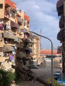 a building with clothes drying on a balcony and a street light at Simple gem in port said in Port Said