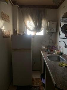 a small kitchen with a sink and a window at Simple gem in port said in Port Said