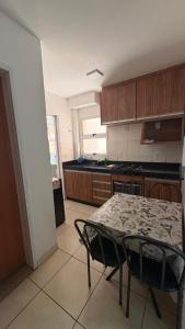 a kitchen with a table and chairs in a room at Apartamento in Rio Verde