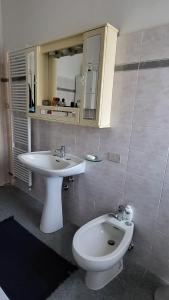 a bathroom with a white toilet and a sink at Appartamento il roseto Gubbio in Gubbio +10 photos