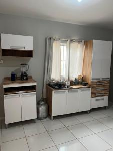 a kitchen with white cabinets and a counter top at Casa in São Raimundo Nonato +4 photos
