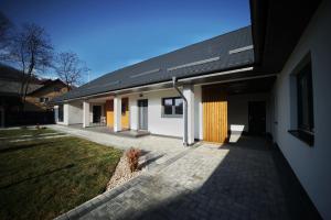 a white building with a black roof at Casa Ana 450 in Sita Buzăului