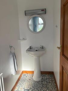 a bathroom with a sink and a mirror at Orchard Cottage in Loughgall +52 photos