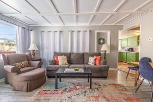 a living room with a couch and a table at Rustic 2 Bedroom Boho Apartment in Laramie